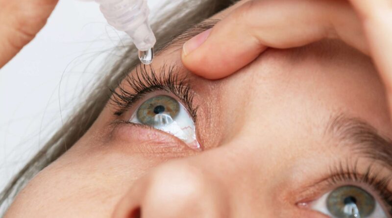 Mujer aplicando gotas para salud visual en su ojo derecho