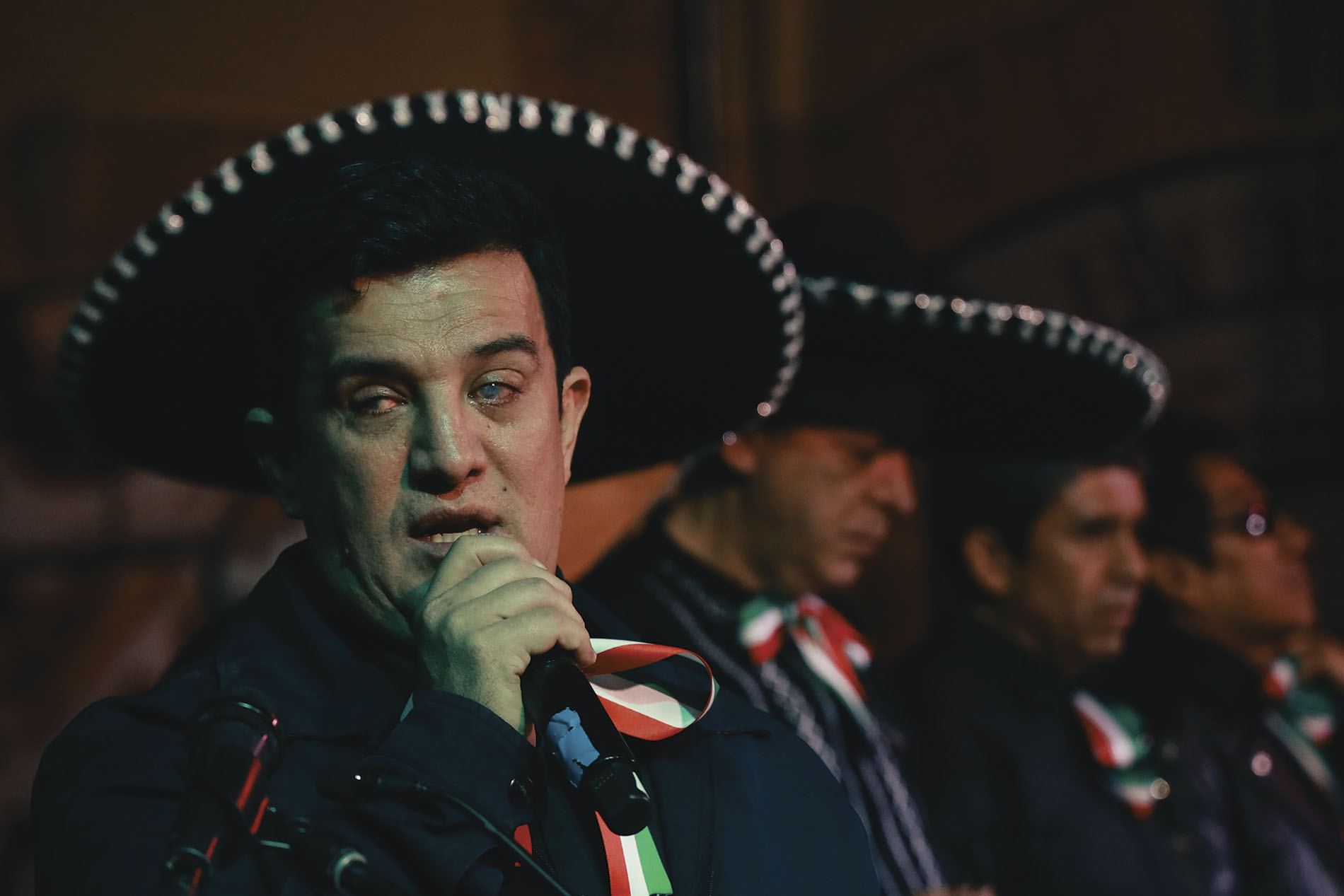 hombre con problemas de visión cantando con mariachi
