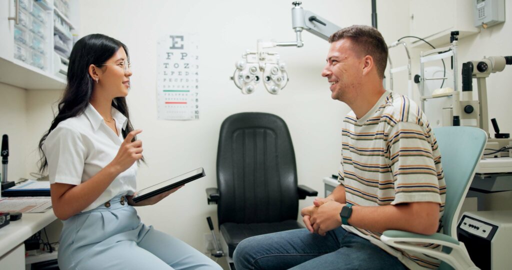 Optometry, tablet and woman with patient in clinic for medical service, consulting and eye exam. Healthcare, optician and optometrist on digital tech with man for vision, wellness and online results.