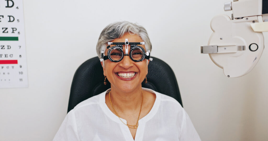 Client, portrait or mature woman in eye test at optometry clinic for